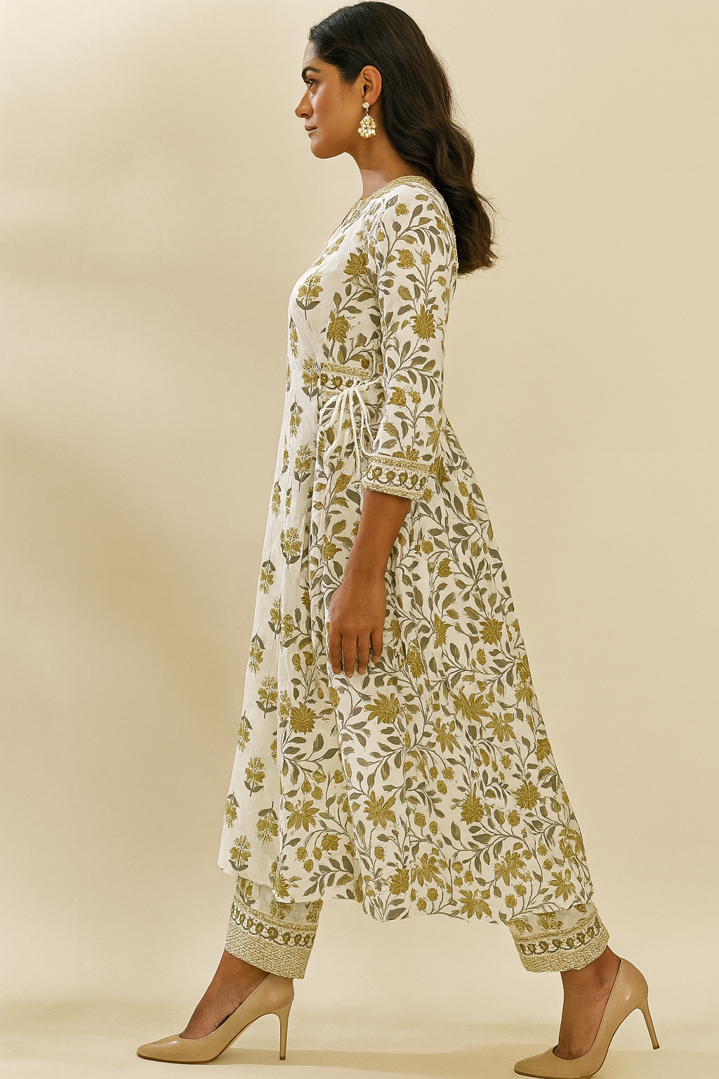 Woman wearing a white floral dress with a beige background