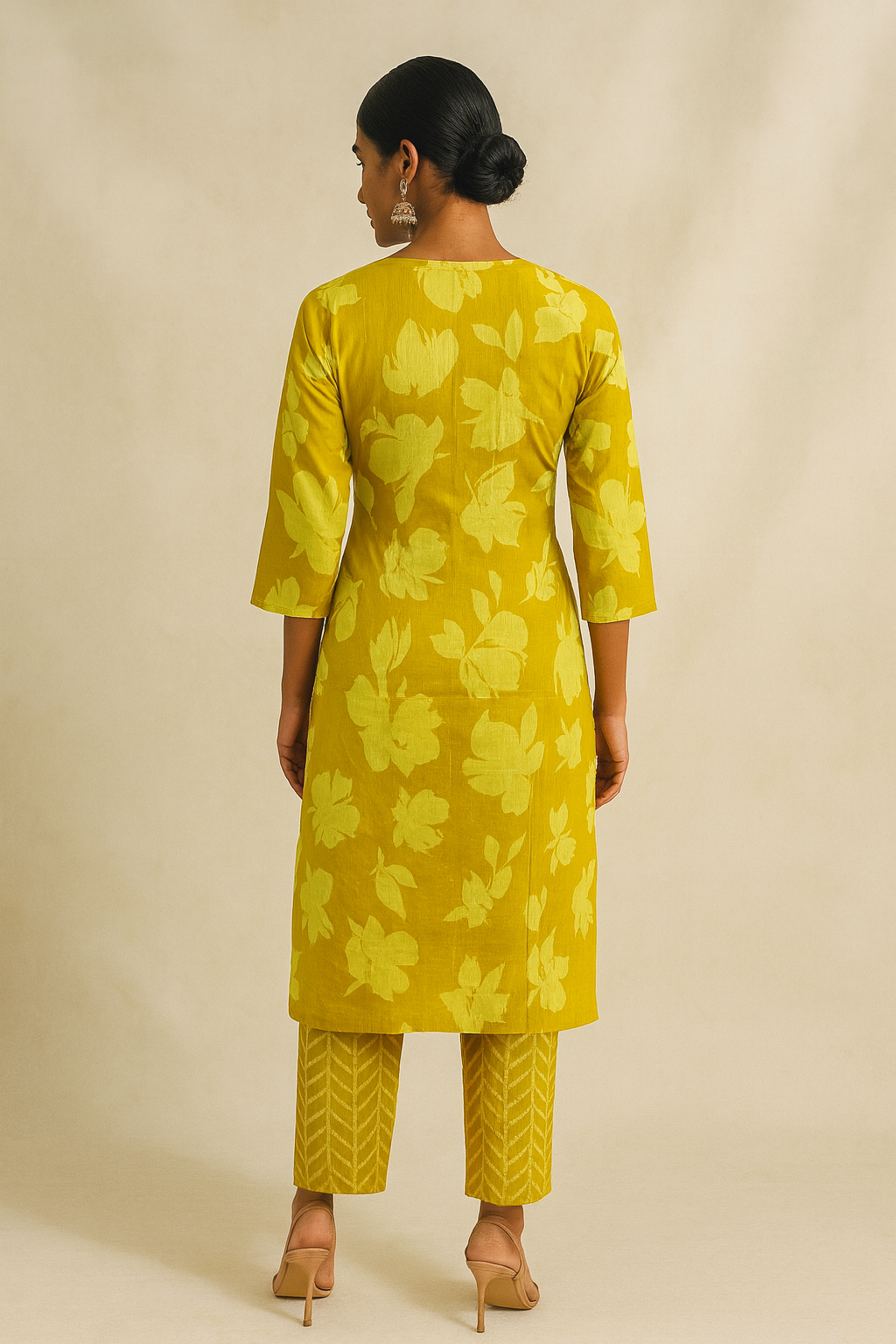Woman wearing a yellow floral outfit on a beige background