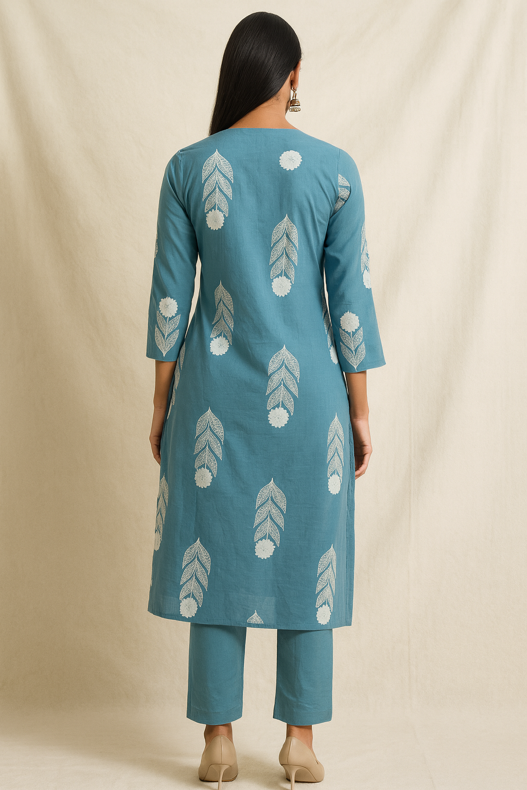 Woman wearing a blue kurta with white patterns on a beige background