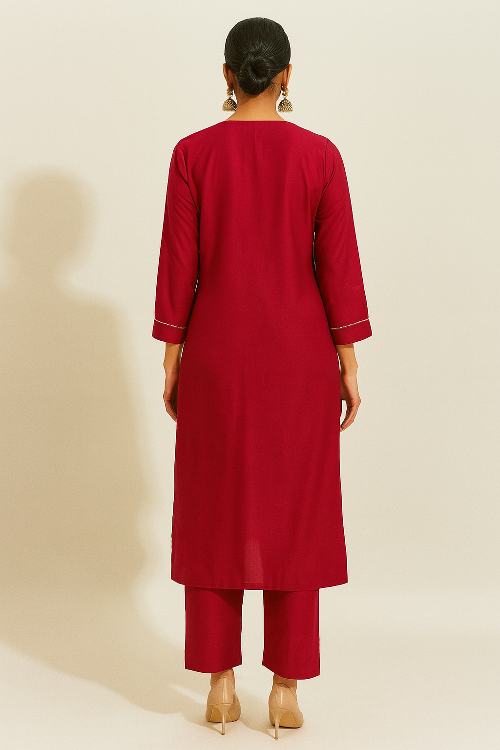 Person wearing a red outfit with a plain background
